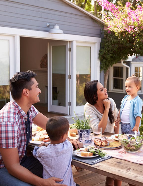 Parents and young family eating lunch outside