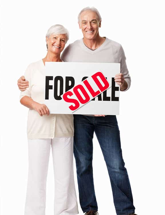 Male and female with a Just sold sign excited about their retirement in Florida