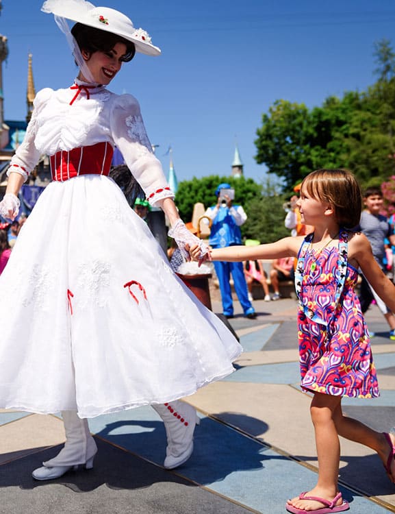 Mary Poppins holding hands with little girl in Disney's Magic Kingdom Orlando