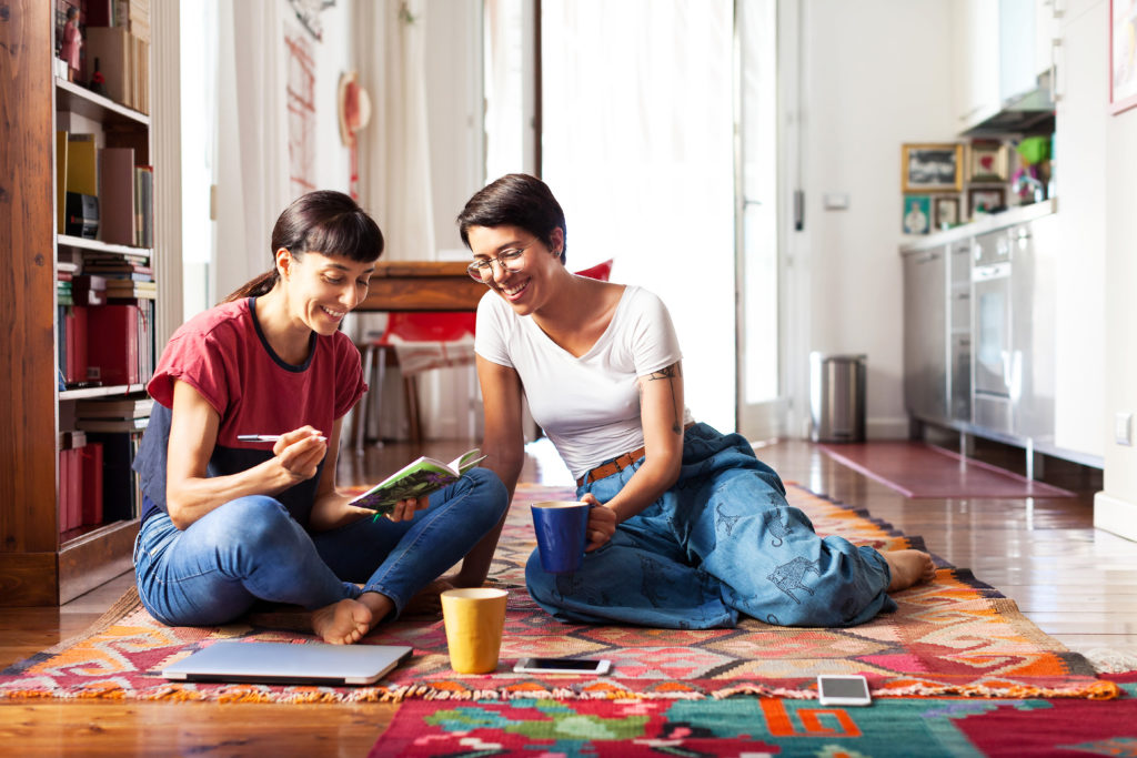 Two young women relaxing at home enjoying free time